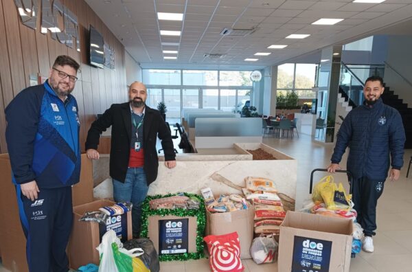 Reunindo os donativos, Marlus Sokolowski, treinador do Foz, Wilson Serrano, do Sicoob, e Jeferson Biron, da diretoria do time – foto divulgação