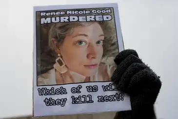 A demonstrator holds a picture of Renee Nicole Good as people protest against the fatal shooting of Good by a U.S. Immigration and Customs Enforcement (ICE) agent, during a rally against increased immigration enforcement across the city outside the Whipple Building in Minneapolis, Minnesota, U.S., January 8, 2026. REUTERS/Tim Evans