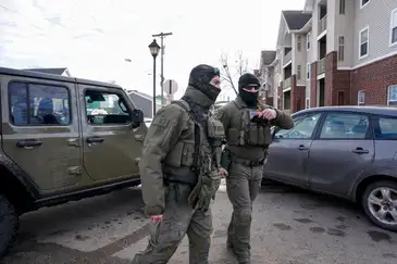 Homeland Security Investigations (HSI) agents stand next to their vehicle after stopping while conducting operations, following the fatal shooting of Renee Nicole Good by a U.S. Immigration and Customs Enforcement (ICE) agent, in a neighborhood in south Minneapolis, Minnesota, U.S., January 12, 2026. REUTERS/Seth Herald